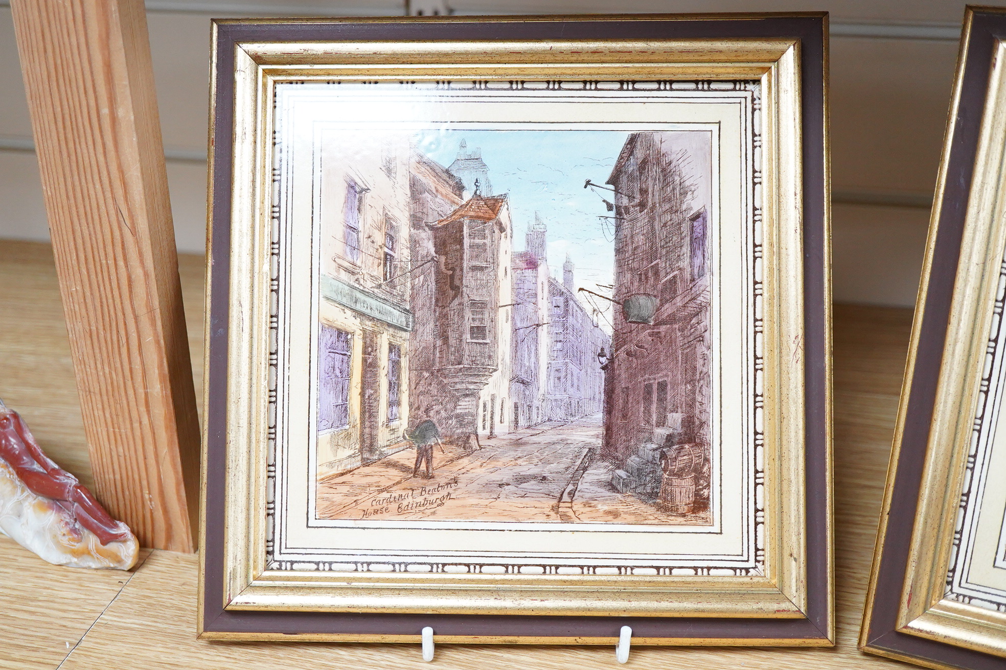 A pair of Stoke-On-Trent pottery scenic glazed tiles, 'Corner Gate Foot Edinburgh' and 'Cardinal Benton's House', framed, 19cm x 19cm